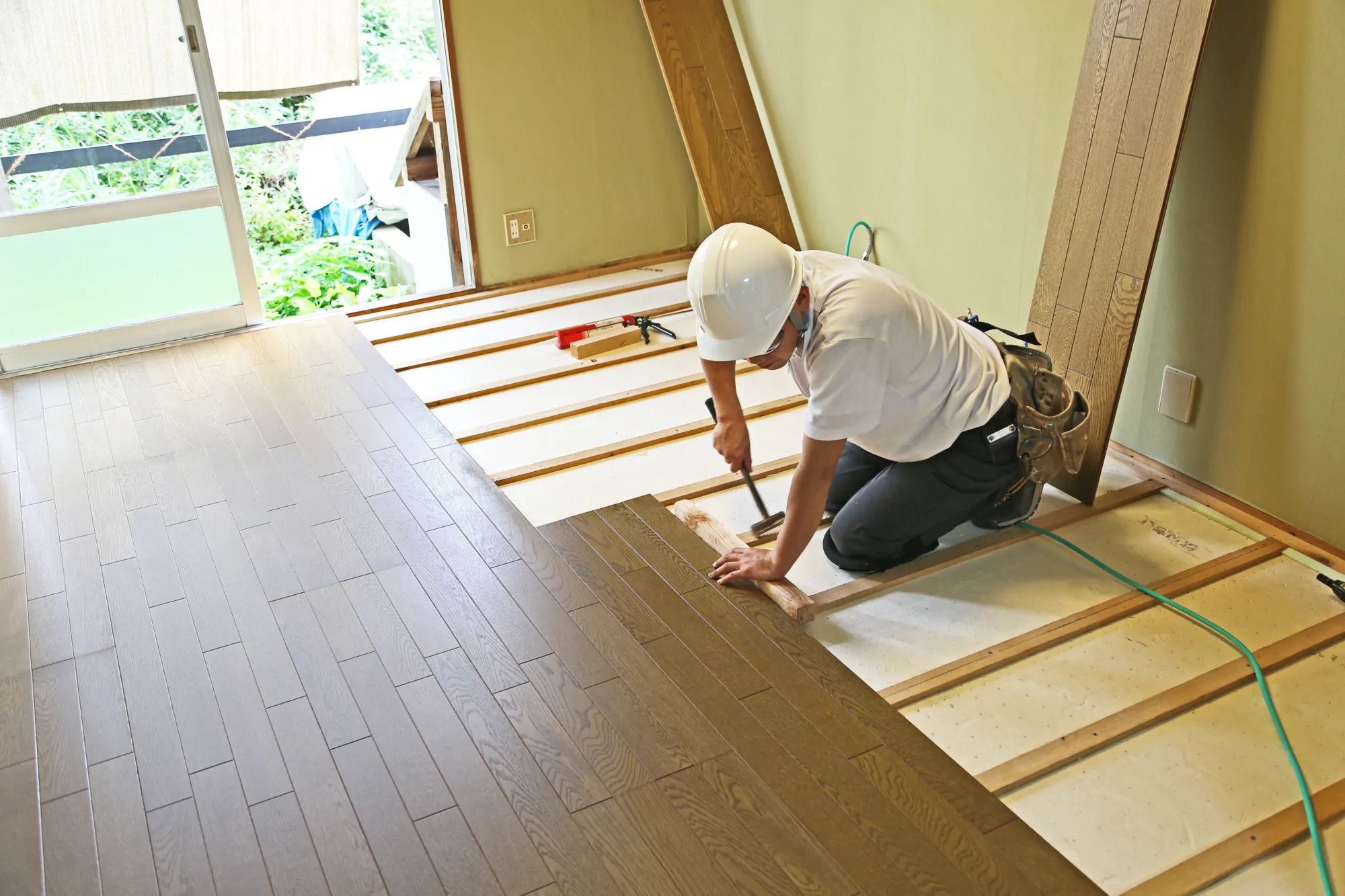 Floor Fitter Installing Wooden Floor